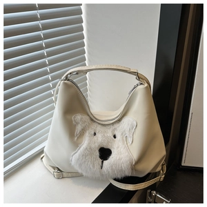 Detail of hobo bag in creamy white faux leather with fluffy dog pattern and zip closure