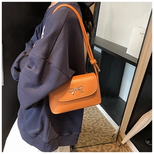 Orange lychee grain leather shoulder bag featuring a silver bow buckle decoration