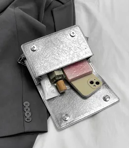 Detailed interior of silver textured crossbody bag showing daily essentials storage space