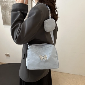 Light blue pleated crossbody bag with metal butterfly and round coin purse
