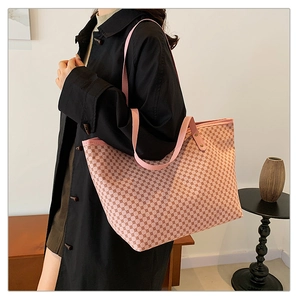 Detail view of pink checkered tote bag showing smooth PU leather strap and spacious interior
