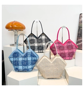 Chic tweed tote bags with fringe trim and V-shaped cutouts in various colors on display