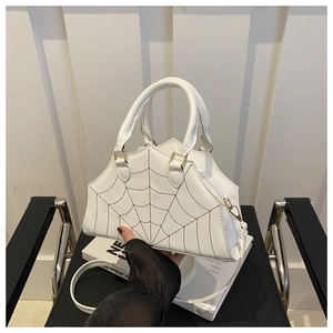 Close-up of spider web stitching on white leather crossbody bag with metal zipper detail