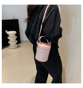 Pink bucket bag with vintage floral pattern embroidery shown on a model