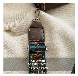 Detail of adjustable ethnic woven strap with brown leather and metal hardware buckle