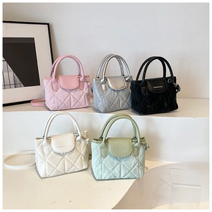 Five assorted colors of quilted crossbody bags on white display stands with a modern look