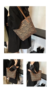 Detailed close-up of leopard print tote bag featuring brown leather straps and fashion label