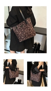 Macro detail of leopard print tote bag featuring black leather handles and fashion logo