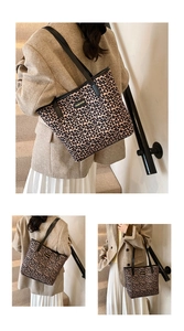 Close-up of leopard print tote bag with gold FASHION text and black shoulder straps