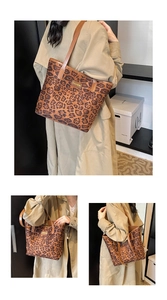 Detail of leopard print tote bag featuring brown leather straps and fashion metal logo