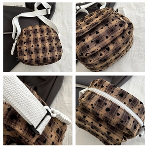 Detail view of retro plaid canvas bag with heart pattern and dual zipper layers