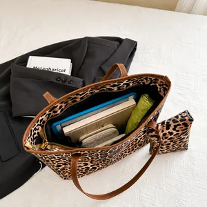 Detailed view of the large leopard print tote bag interior and matching pouch