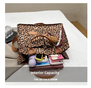 Detailed view of the spacious interior of the leopard print tote bag with daily items