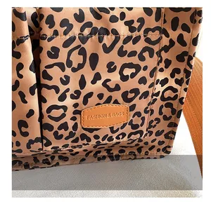 Close-up of leopard print canvas tote with leather patch detail and durable nylon fabric