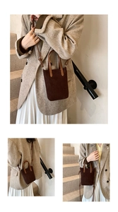 Detail of dark chocolate faux suede mini tote bag showing texture and leather handle