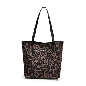 Large leopard print suede tote bag with black shoulder straps and fashion metal label