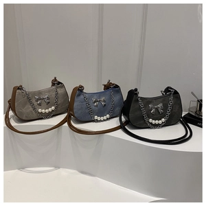 Detailed display of retro underarm bags with pearl chains and metal bow decorations