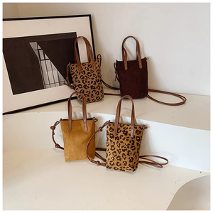 Mini crossbody phone bags in leopard print and suede finish on a display stand