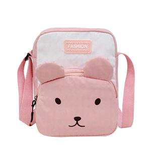 Pink and white canvas crossbody bag with cartoon bear design and adjustable strap