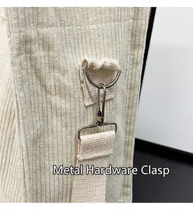 Detail shot of sturdy metal hardware and strap connector on corduroy tote bag