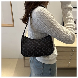 Detail of vintage monogram shoulder bag with M pattern on a chic crescent silhouette