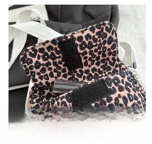 Detailed macro view of the leopard print crossbody bag featuring a Velcro flap closure