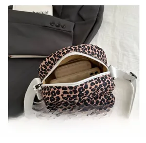 Detailed top view of leopard print crossbody bag showing spacious interior for phone and wallet