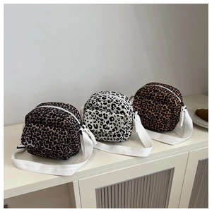 Detailed comparison of leopard print crossbody bags in grey, white, and brown canvas