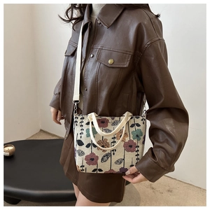 Detail of vintage floral jacquard tote bag with detachable canvas shoulder strap