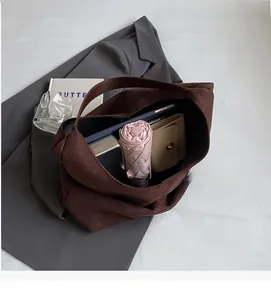 Internal view of large capacity dark brown suede tote bag showing storage for daily items