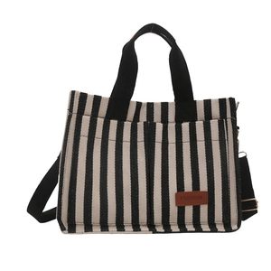 Minimalist black and white striped canvas tote bag with adjustable shoulder strap