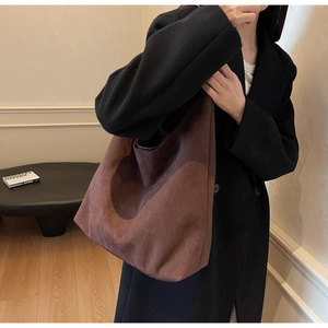 Deep coffee large suede tote bag carried by model over a black winter wool coat