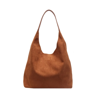 Minimalist large dark brown suede hobo tote bag with slim shoulder strap on white background