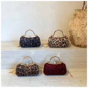 Elegant leopard print evening clutches with gold circular handles and rhinestone clasps