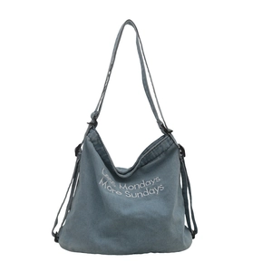Blue denim tote bag with Less Mondays More Sundays print and adjustable strap