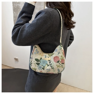 Floral jacquard crescent shoulder bag detail shown on model with vintage flower pattern