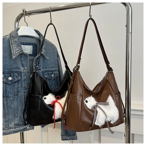 Minimalist faux leather tote bag with plush puppy appliqué and wide shoulder strap