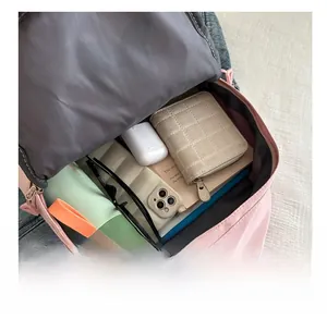 Pink nylon backpack showing large storage capacity for laptop, water bottle and wallet