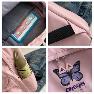 Detail view of pink student backpack with butterfly print and padded laptop compartment