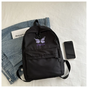 Detail of black backpack with purple gradient butterfly print and Dreams text design