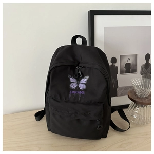 Detail shot of the black canvas backpack featuring purple butterfly and Dreams text print