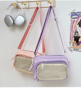 Detail of pink and purple transparent ita bags featuring mesh pockets and adjustable straps