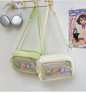 Detail of canvas crossbody bag with transparent mesh pocket and cartoon rabbit badges