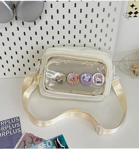 Detail view of cream white crossbody bag featuring transparent mesh pocket with rabbit badges
