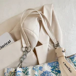 Detail of blue and silver floral jacquard tote bag with stylish canvas woven handles