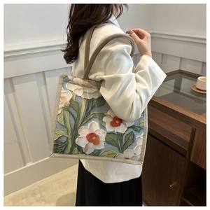 Detail of artistic floral oil painting print on texture beige linen tote handbag