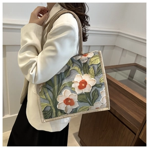 Detailed view of floral relief print and textured jute fabric on a stylish tote bag