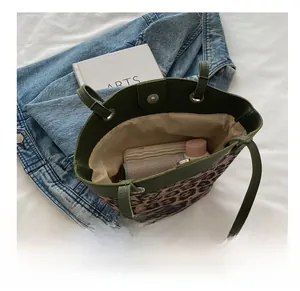 Top view of leopard print tote bag with green leather trim showing spacious interior storage