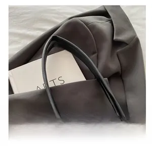 Detail view of the vintage purple patterned tote bag with durable black leather handle