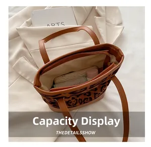 Top view of leopard print tote bag showing internal zipper compartment and large capacity